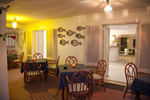 a dining room with tables and chairs and yellow walls at Park Hotel Silemi in Letojanni