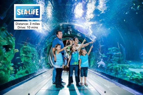 a family in an aquarium at the aquarium at Media City Salford Quays in Manchester