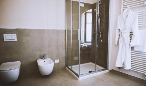 a bathroom with a shower and a toilet and a sink at Moonfrà in Antignano