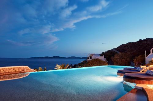 a swimming pool with a view of the ocean at Katikies Mykonos - The Leading Hotels of the World in Agios Ioannis Mykonos