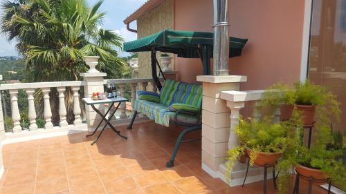 a porch with a couch and a table on a balcony at Villa SportLife in Lloret de Mar