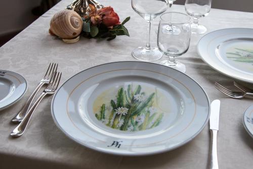 a table with a white plate and silverware on it at Park Hotel Silemi in Letojanni