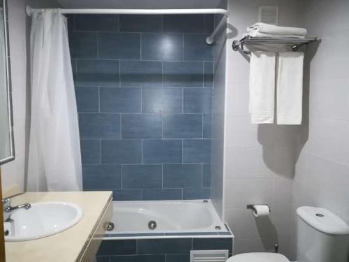 モナチルにあるLa Casita de Gonzaloの青いタイル張りのバスルーム(バスタブ、シンク付)