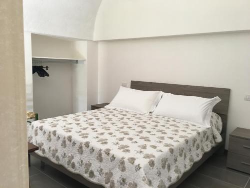 a bedroom with a large bed with white pillows at Lamia Bianca in Locorotondo