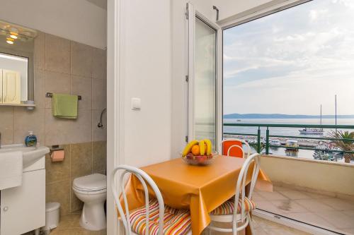 a bathroom with a table and a view of the ocean at Pink in Tučepi