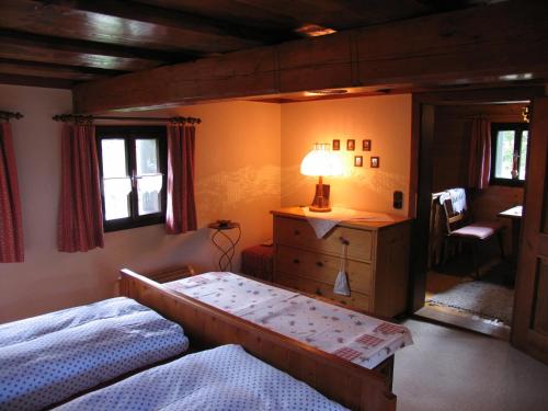 a bedroom with a bed and a dresser with a lamp at Ferienhaus "Badl" in Bad Goisern