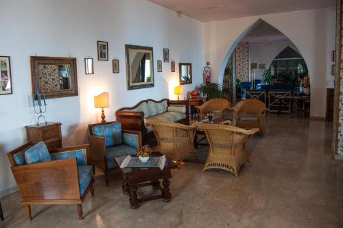 a living room with couches and chairs and tables at Park Hotel Silemi in Letojanni