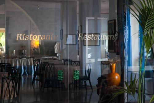 a dining room with a table and chairs at Park Hotel Silemi in Letojanni