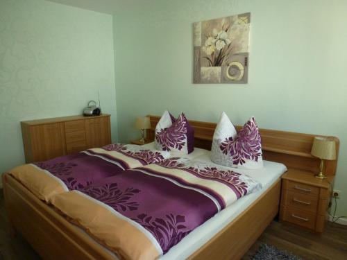 ツィノヴィッツにあるFerienwohnung Glienbergwegの紫と白のシーツと枕が備わるベッド1台
