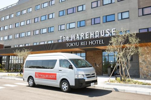 a white van parked in front of a hotel at Kawasaki King Skyfront Tokyu REI Hotel in Kawasaki