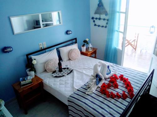 a bedroom with a bed with two stuffed animals on it at Paradisso Studios in Vromolithos