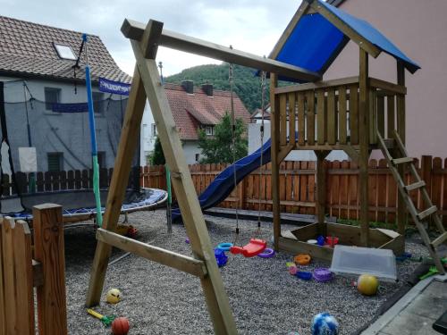 a playground with a slide and a swing set at Ferienwohnung Epple in Bad Urach