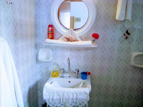 a bathroom with a sink and a mirror at Paradisso Studios in Vromolithos