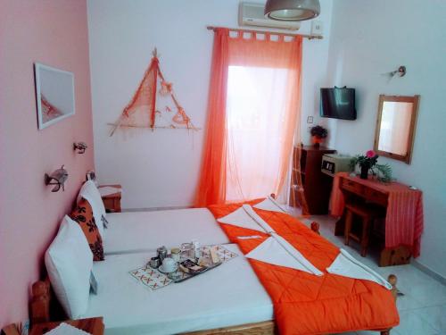 a room with a bed and a table in it at Paradisso Studios in Vromolithos