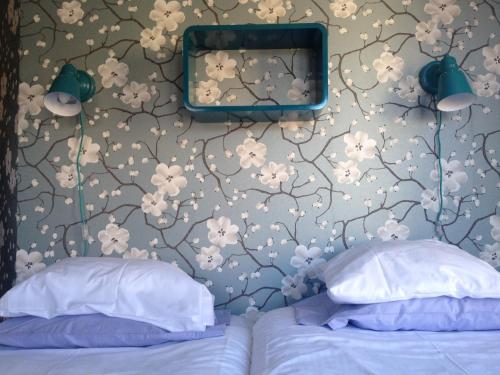 a bedroom with a wall with a flowery wallpaper at Best Western Uppsala in Uppsala