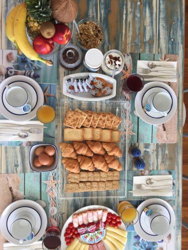 a table topped with plates and bowls of food at Villa Serenity in Porto Rafti
