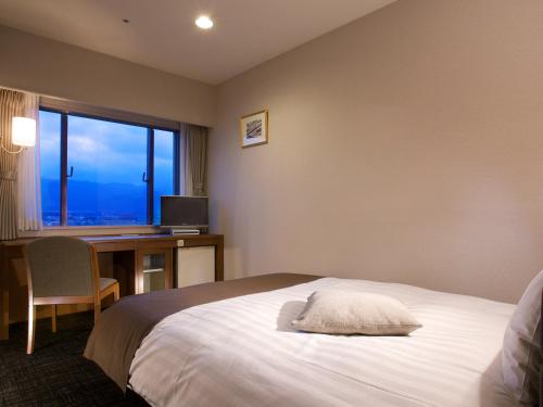 En eller flere senger på et rom på Imazu Sun Bridge Hotel