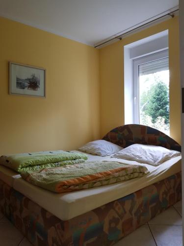 a bed sitting in a room with a window at Ranczo u Nikodema in Silice