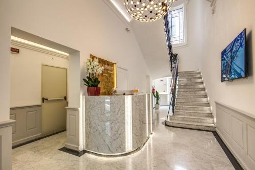 a lobby with a marble counter and stairs at The Liberty Boutique Hotel in Rome