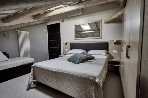 a bedroom with two twin beds and a mirror at Rouge Hotel International in Milano Marittima