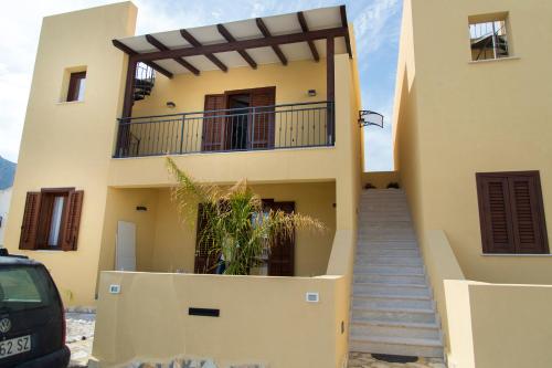 a house with a staircase in front of it at Casa Vacanze Fontana in San Vito lo Capo