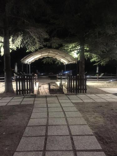 a park at night with trees and a pavilion at Casale Fusco in Spoleto