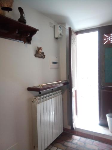 a room with a radiator and a window at Calì B&B in Alatri