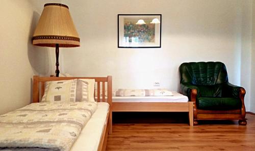 a bedroom with a bed and a lamp and a chair at Villa Teleki in Teleki