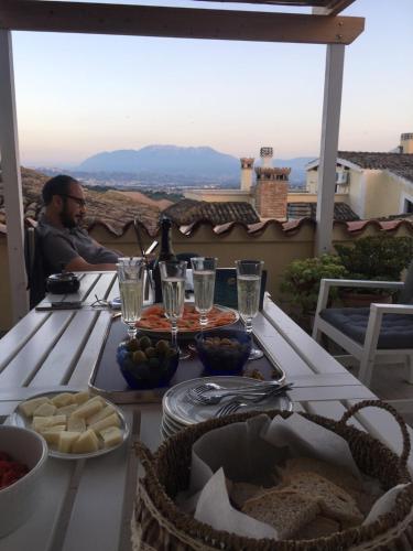 a man sitting at a table with food on it at BellaVista Bike Stop in Spoltore