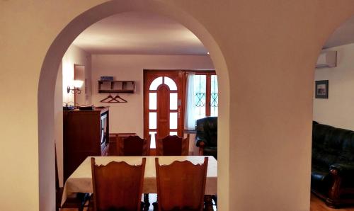 a dining room with a table and chairs at Villa Teleki in Teleki