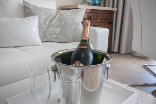 a bottle of wine in a bucket on a table with two glasses at Doñana 1109 in Patalavaca