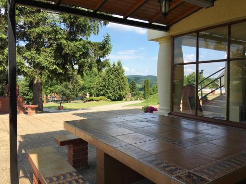 a patio with a bench and a view of a park at Villa Teleki in Teleki
