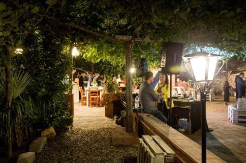 a man sitting on a bench in a garden at night at Tenuta TerraRossa in Rossano