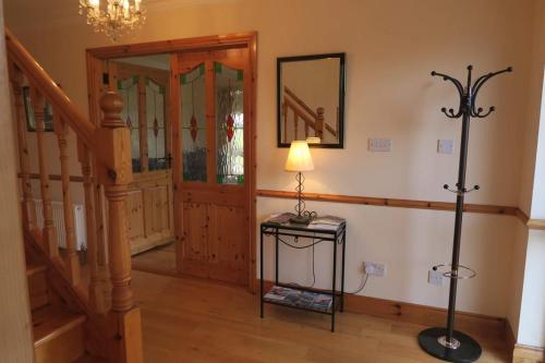 a room with a staircase and a lamp on a table at THISTLEDOWN - Ballina - Crossmolina - County Mayo - Sleeps 8 - Sister property to Inglewood in Ballina
