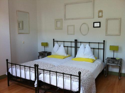 a bedroom with a large bed with yellow pillows at B&B Het Venloos Plekje in Venlo