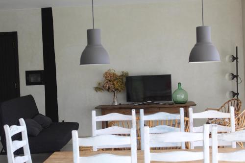 a living room with a table and chairs at Casa Rural ABARAXKA- Espectaculares Vistas a las Verdes Montañas a sólo 20 minutos de la Playa" in Azcoitia