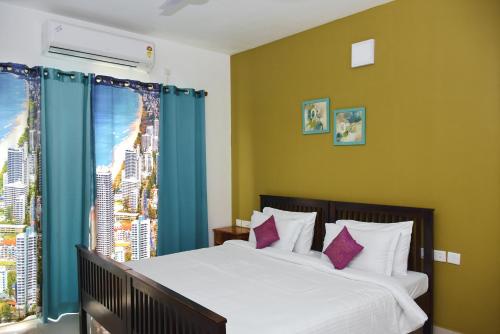 a bedroom with a bed with a view of a city at LE Chalet - Serviced Luxury Condominium in Ahmedabad