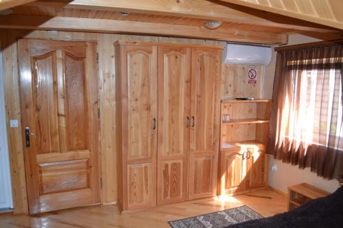 a room with a large wooden door in a house at У Гуцула in Mukacheve