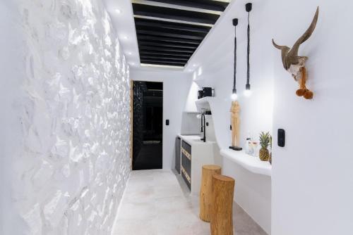a room with white walls and a white wall at Portara Seaside Luxury Suites in Naxos Chora