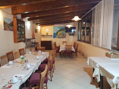 a dining room with white tables and chairs at Hotel Gentile in Agerola
