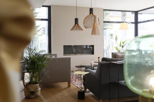 a living room with a couch and a fireplace at James Boutique Hôtel Colmar centre in Colmar
