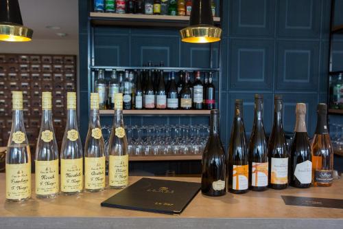a bunch of bottles of wine sitting on a bar at James Boutique Hôtel Colmar centre in Colmar