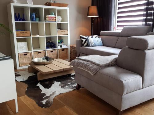 a living room with a couch and a chair at Bluebeach Scheveningen in Scheveningen