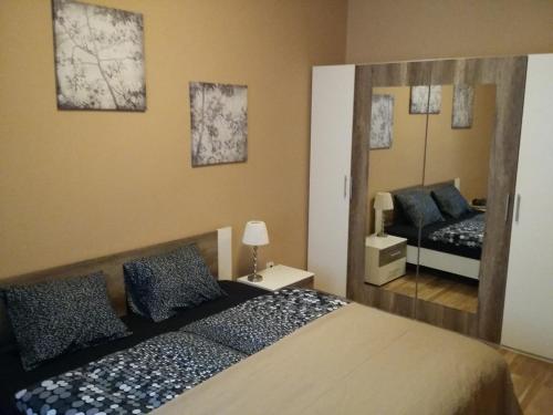 a bedroom with a large bed and a mirror at Angel apartment nr 4 near to the center in Prague