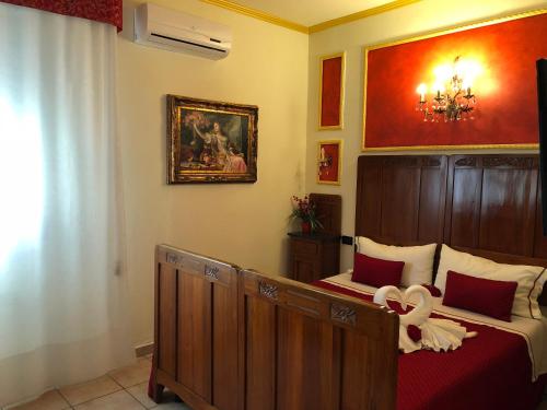 a bedroom with two beds and a picture on the wall at La Dea Hestia in Bosa