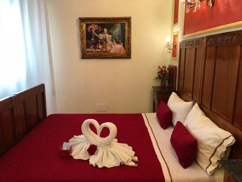 a room with a bed with a heart decoration on it at La Dea Hestia in Bosa