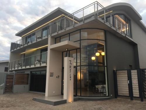 a modern house with a balcony and a building at 7 on Marine in Hermanus