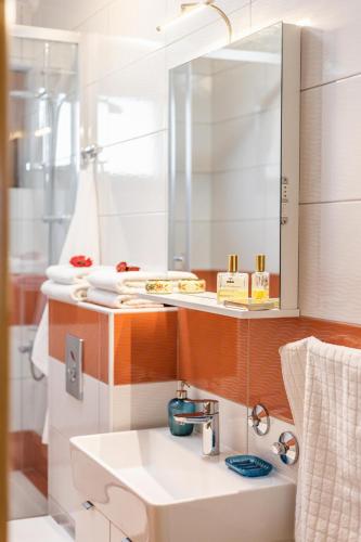 a bathroom with a sink and a mirror at Iva Apartmani in Vodice