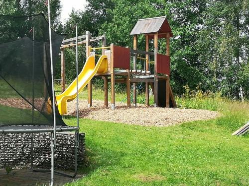 a playground with a slide in the grass at Panoramahotel Stocker in Pruggern