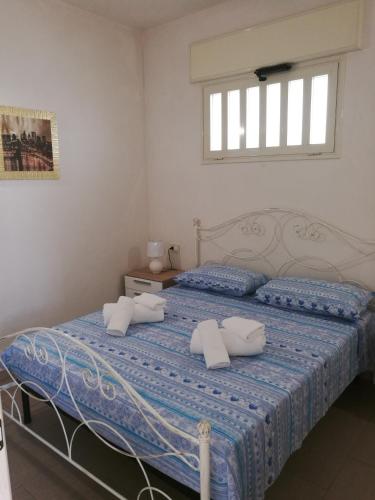 Un pat sau paturi într-o cameră la Cala del Conte 2